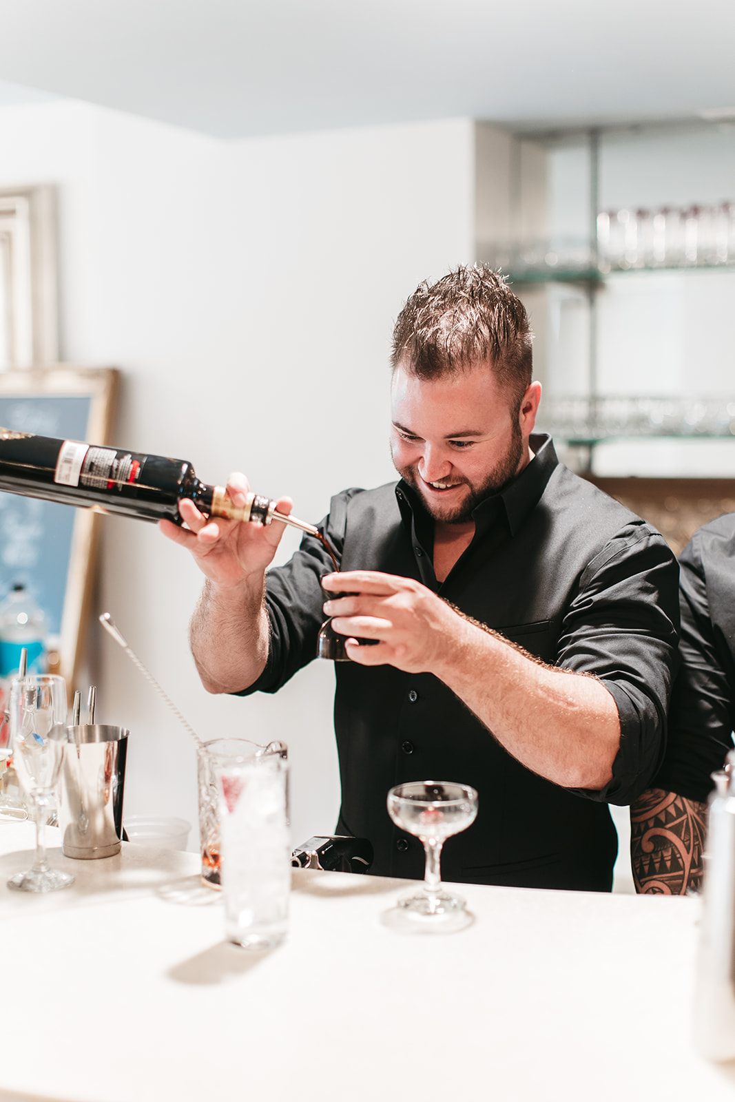 Brendan is pouring cocktails.